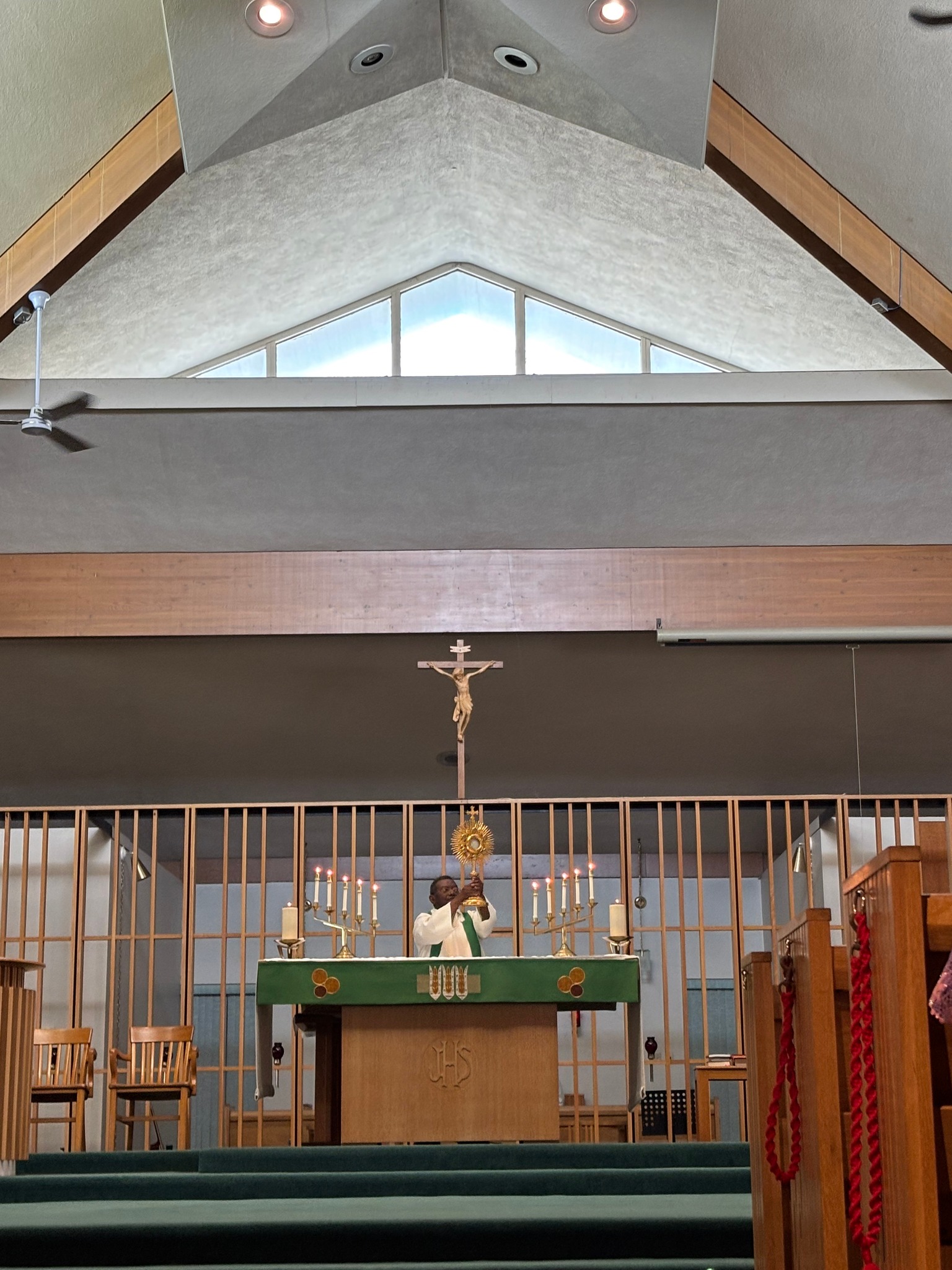 Interior of church with pastor leading Sunday worship service at the altar